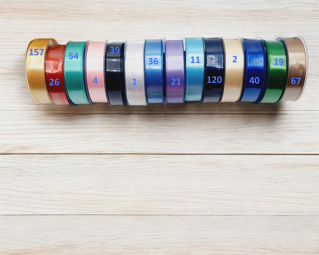 Carte de présentation naissance ronde en bois gravé avec prénom personnalisé et grand nœud en satin crème, style bohème chic.